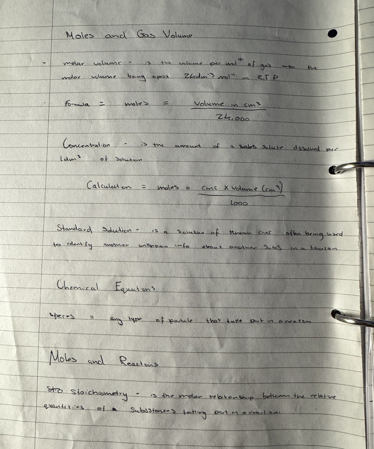 A photo of a handwritten chemistry page on moles and gas volume